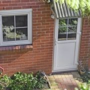 Traditional UPVC residential door with window pane