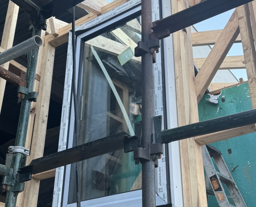 Construction worker installing high-performance windows in a building